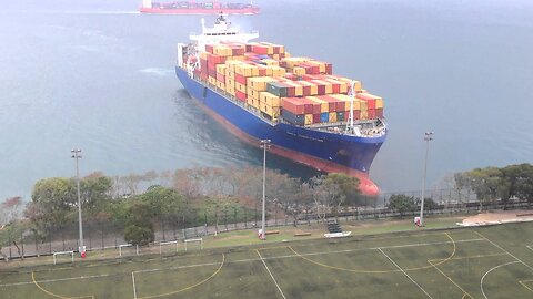 A Maritime Encounter: Container Ship Meets the Shoreline by University Gridiron"