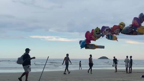 Balloon Salesman Walks Beach