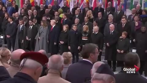 Russian President Vladimir Putin walks in front of world leaders