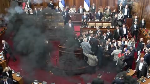 Serbian Lawmakers Fight, Lob Smoke Bombs In Dramatic Parliamentary Session