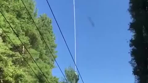 Helicopter trims trees around power lines