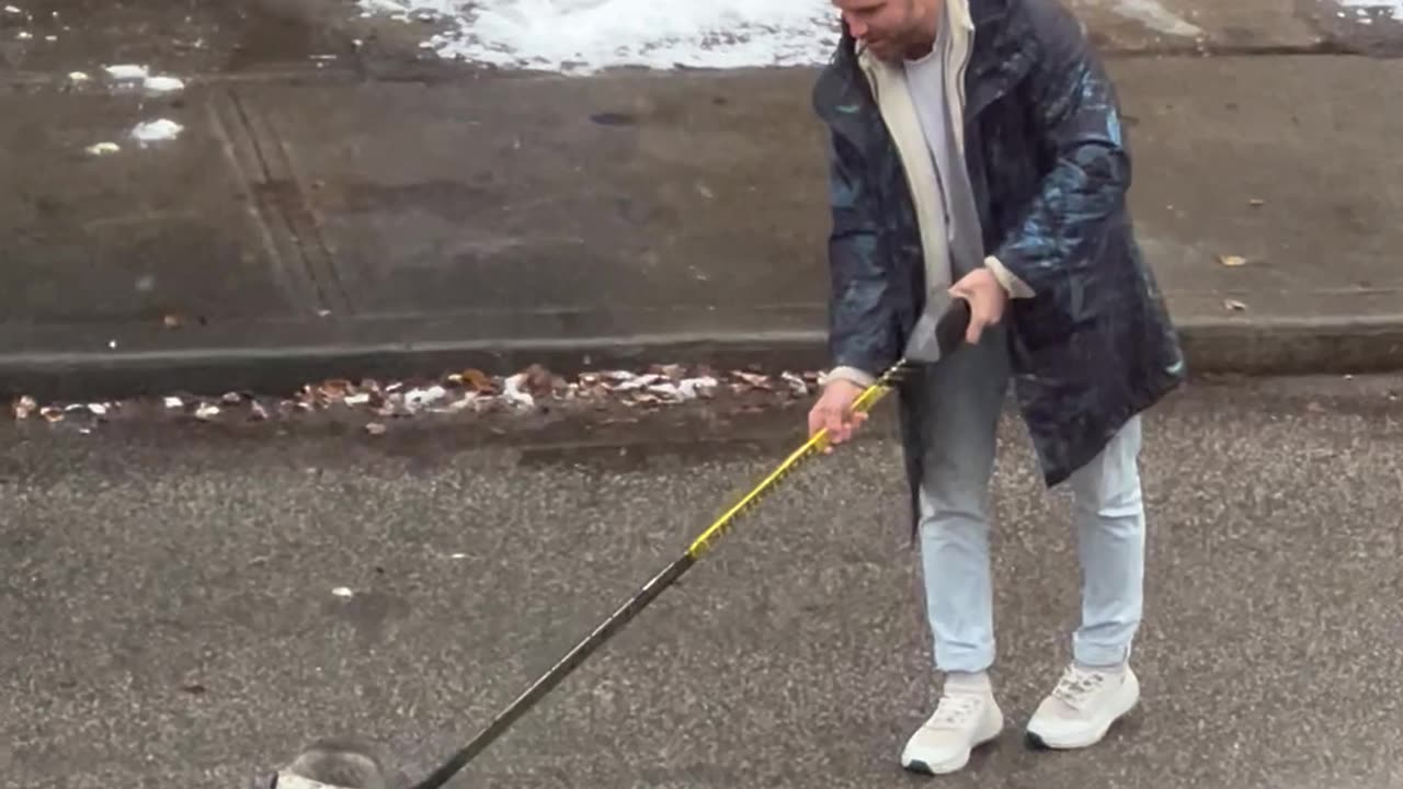 Canadian Helps Guide a Raccoon Using a Hockey Stick