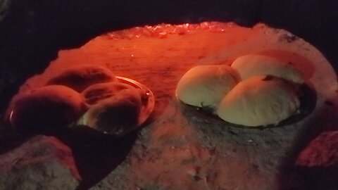 homemade bread cooking in sandstone oven off grid