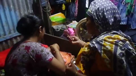 A child being circumcised by a village woman 
