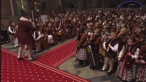 hundreds of children donned in folk costumes played at the Church of St Magdalene