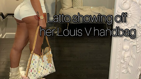 Latto showing off her new Louis Vuitton handbag