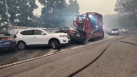Bulldozer is being used to move abandoned cars out of the way - the Palisades Fire