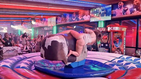 Pretty Girl in Beautiful Dress Riding on a Bull in Benidorm - Mechanical Bull 4K. Epic Fail August