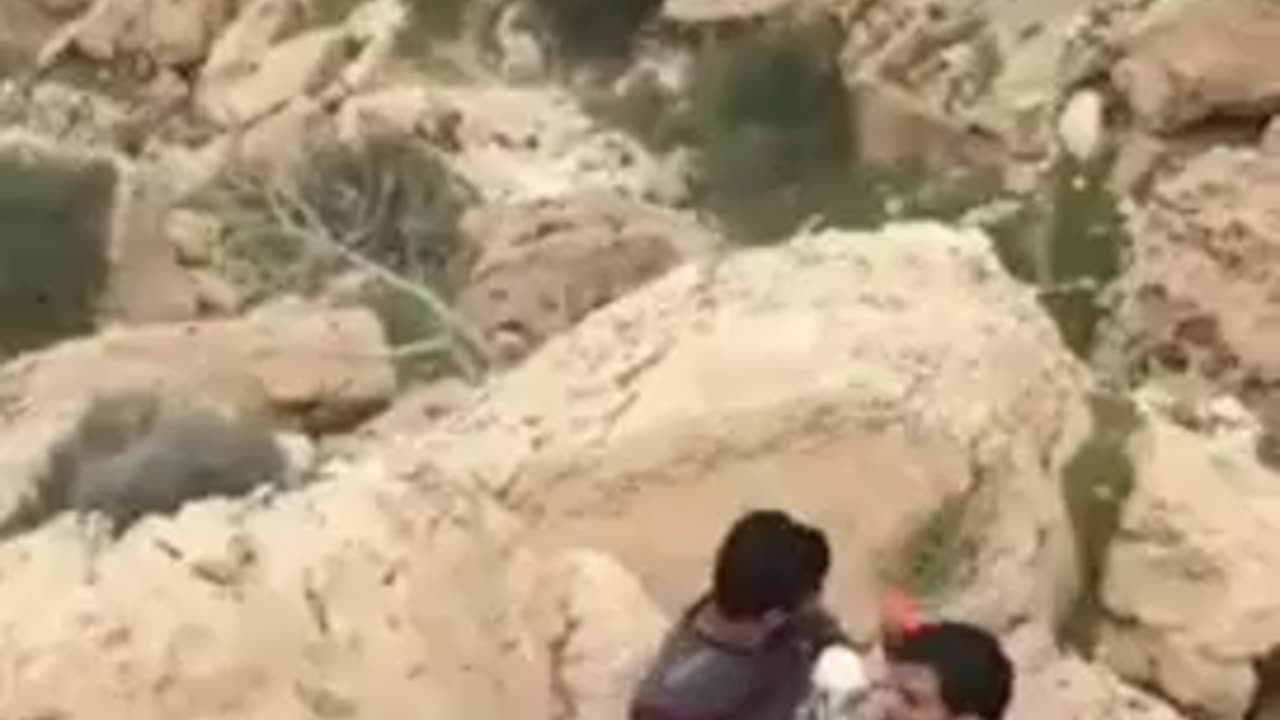 Zipline breaks, sending guys tumbling down a rocky hillside