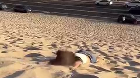 GIRL FALLING ON THE BEACH