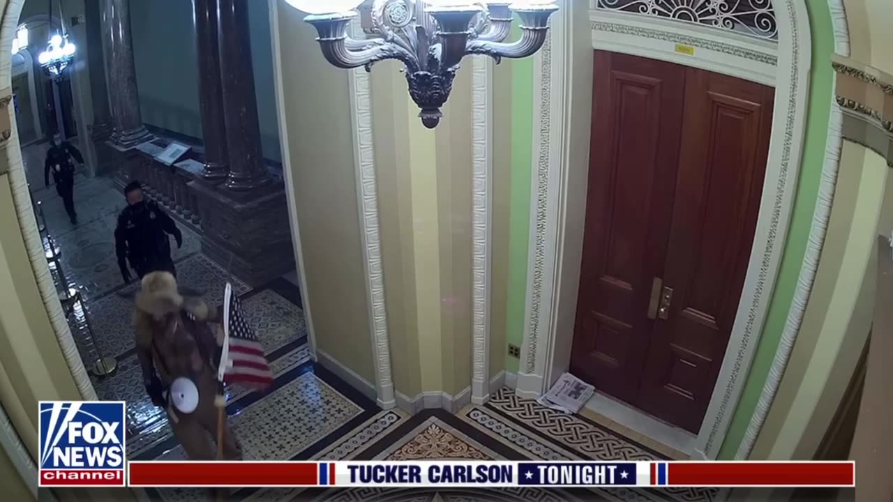 Tucker Carlson shows the Capitol Police escorting the “QAnon Shaman” through the Capitol building