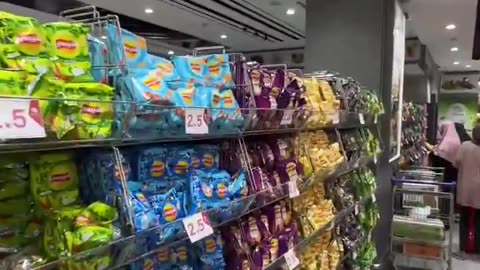 Palestinian man shows off abundance of fresh food in a Gaza supermarket