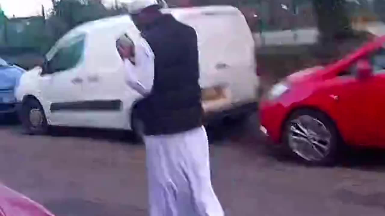 A woman protests at a mosque in the UK about rights for Afghan women.