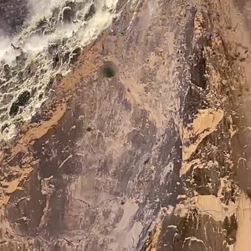 Mountain Goats running on the sides of a sheer cliff