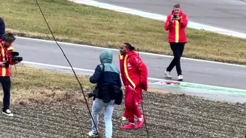 Crowds watch as Lewis Hamilton drives Ferrari's test track