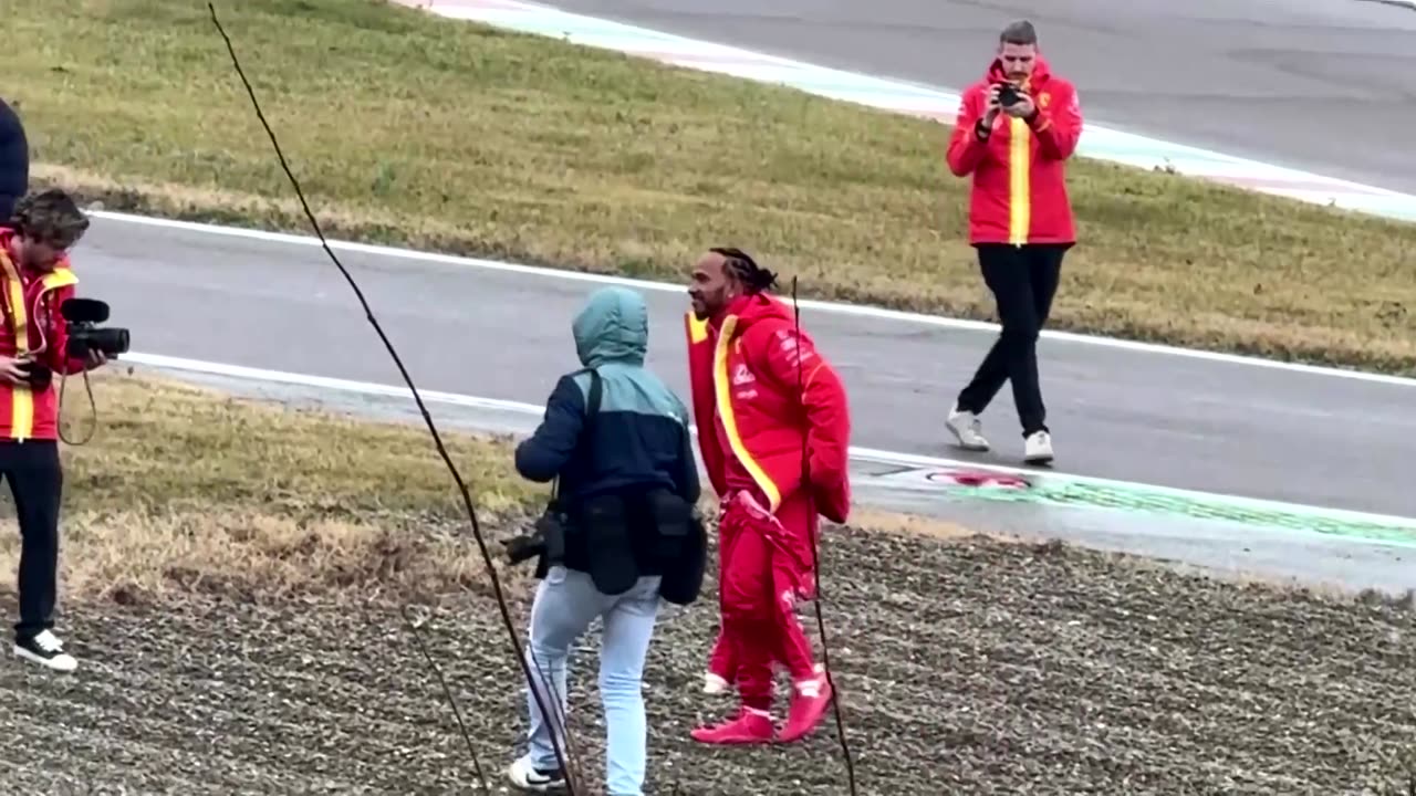 Crowds watch as Lewis Hamilton drives Ferrari's test track