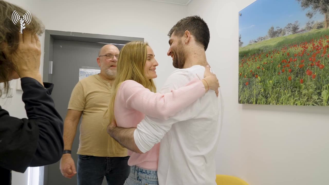 Released hostage Sagui Dekel-Chen reunites with his wife Avital at an IDF facility