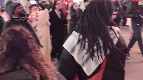 Protestors in Times Square: "HANDS OFF PALESTINE"