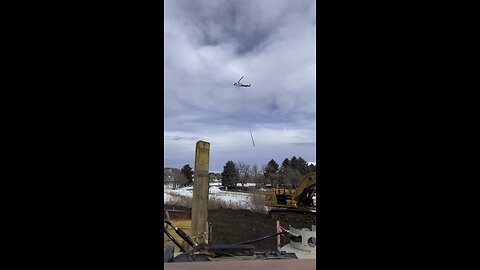 Helicopter flying new power pole