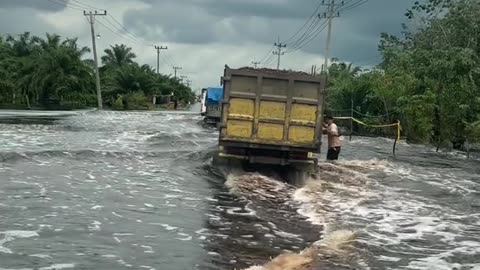 The truck overturned due to flooded roads