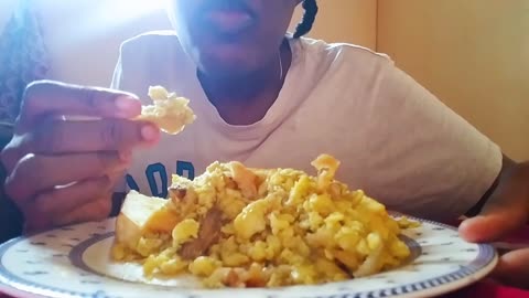 Eating jamaica ackee and saltfish with roasted breadfruit