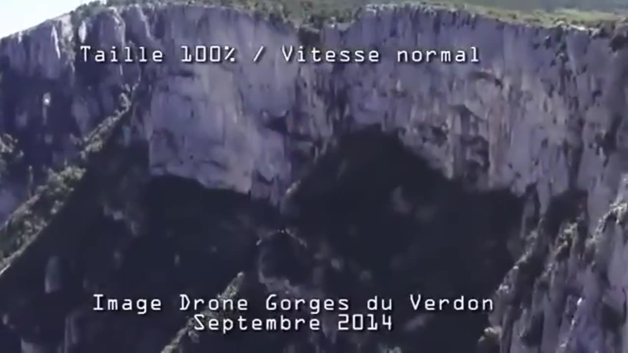 French drone films an unknown object disappear through the solid surface of a mountain in 2014.