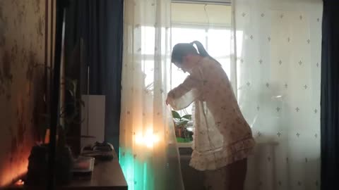 Transparent watering houseplants with model girl in a dress