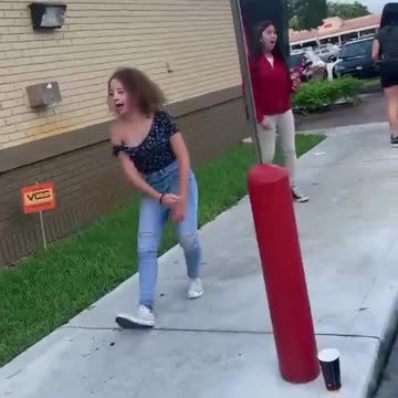 Girls fight outside at a restaurant