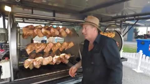 Street Food Magic: Watch These Giant Bratwursts Rotisserie in Italy!