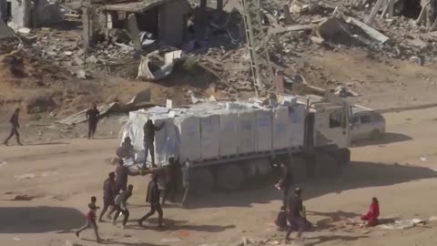 Gazans rush to take aid from moving trucks entering Rafah