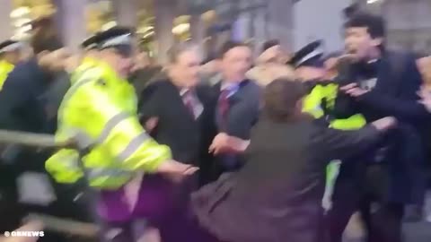 Anti-white English dictator and traitor surrounded by mob