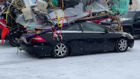 Belongings Strapped Precariously To Sedan Roof