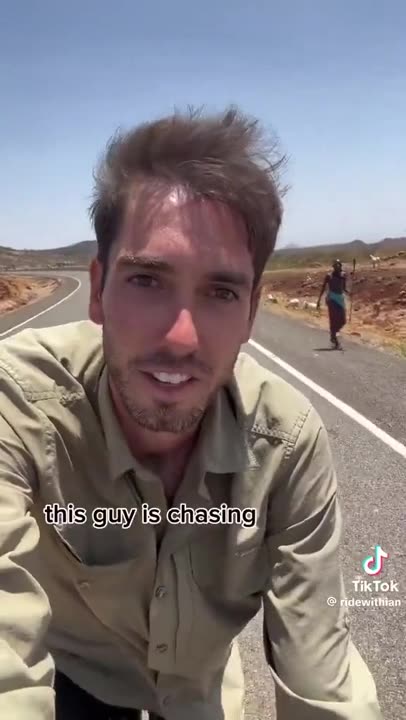 White man biking through Africa gets spears and rocks thrown at him LMFAO