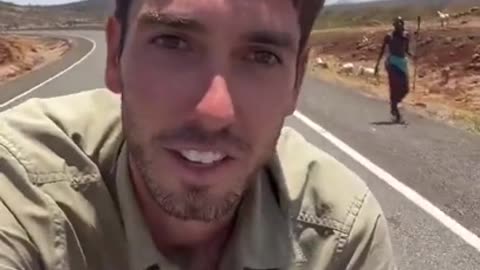 White man biking through Africa gets spears and rocks thrown at him LMFAO