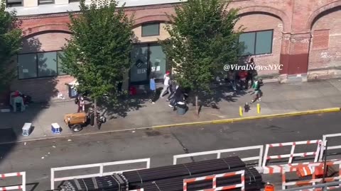 MIgrants running down the street with weapons