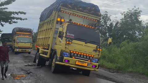 queues of trucks pass along extreme roads