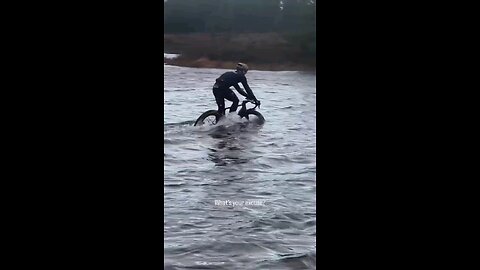 "Man Crosses the River on a Bicycle"