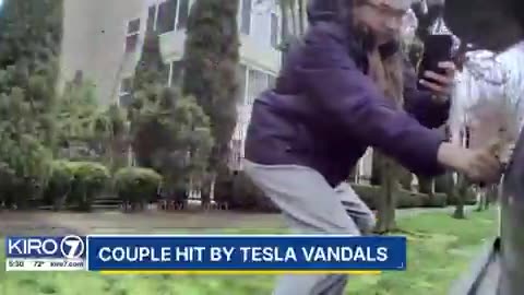 Person is being sought in Seattle after being caught on camera vandalizing a Tesla scratching it
