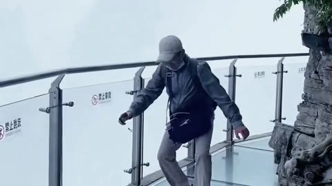 Funny video of people being afraid of falling off a glass bridge on a mountain video 2025 skc.com 95