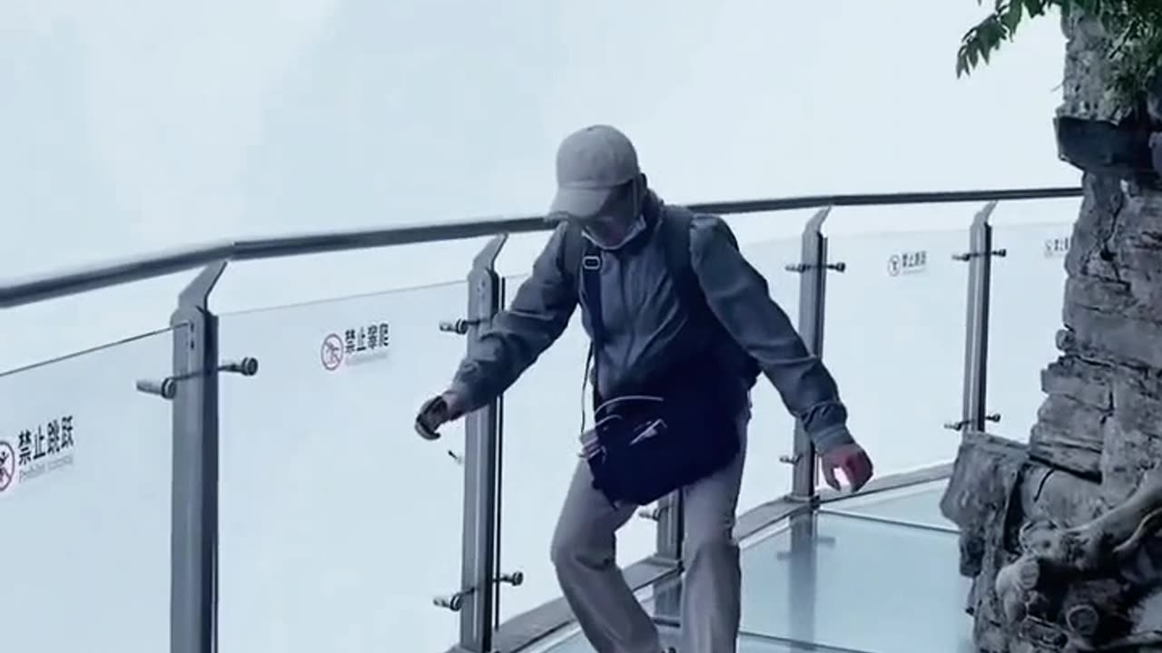Funny video of people being afraid of falling off a glass bridge on a mountain video 2025 skc.com 95