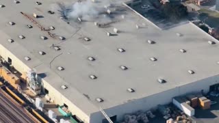 New video of a small plane that has crashed into a commercial warehouse near Fullerton Airport