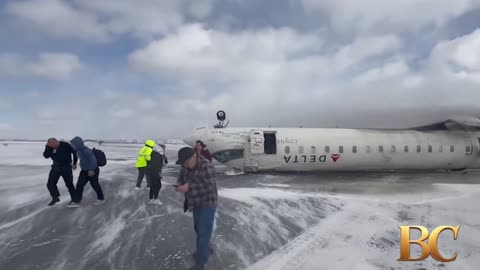 Delta jet flips upside down on a snowy Toronto runway