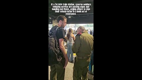 Reservist soldiers in Tel Aviv Israel R distributing flyers & signs urging others 2 refuse service.