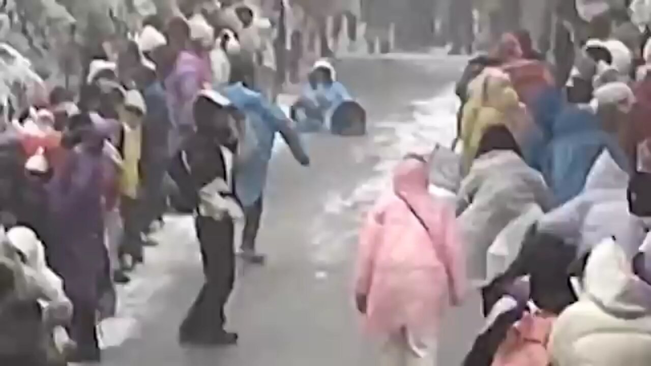 Mother and daughter slide down icy mountain road in China