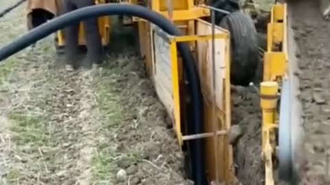 An amazing machine that trenches..lays cable and buries it all in one