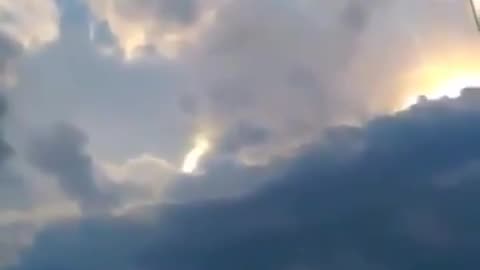 Odd Cloud Formation or UFO Behind the Clouds