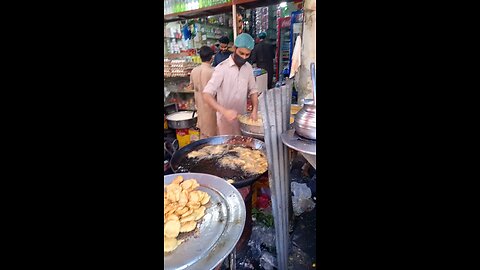 Pakistani streets food potatoes pakora and samosa frying fry