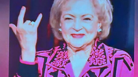 Betty White, throwing up the horns