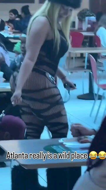 Leftist lunatic woman walks her man like a dog through the mall