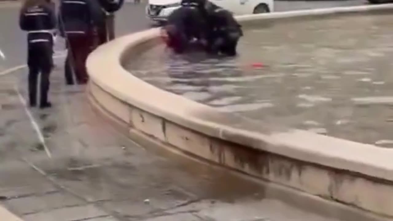 African Migrant naked in fountain - Italy